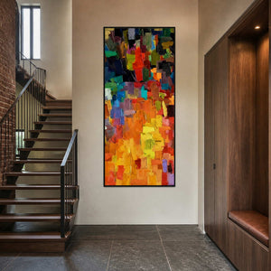 Textured multicolor wall art displayed beside a dark wood staircase.