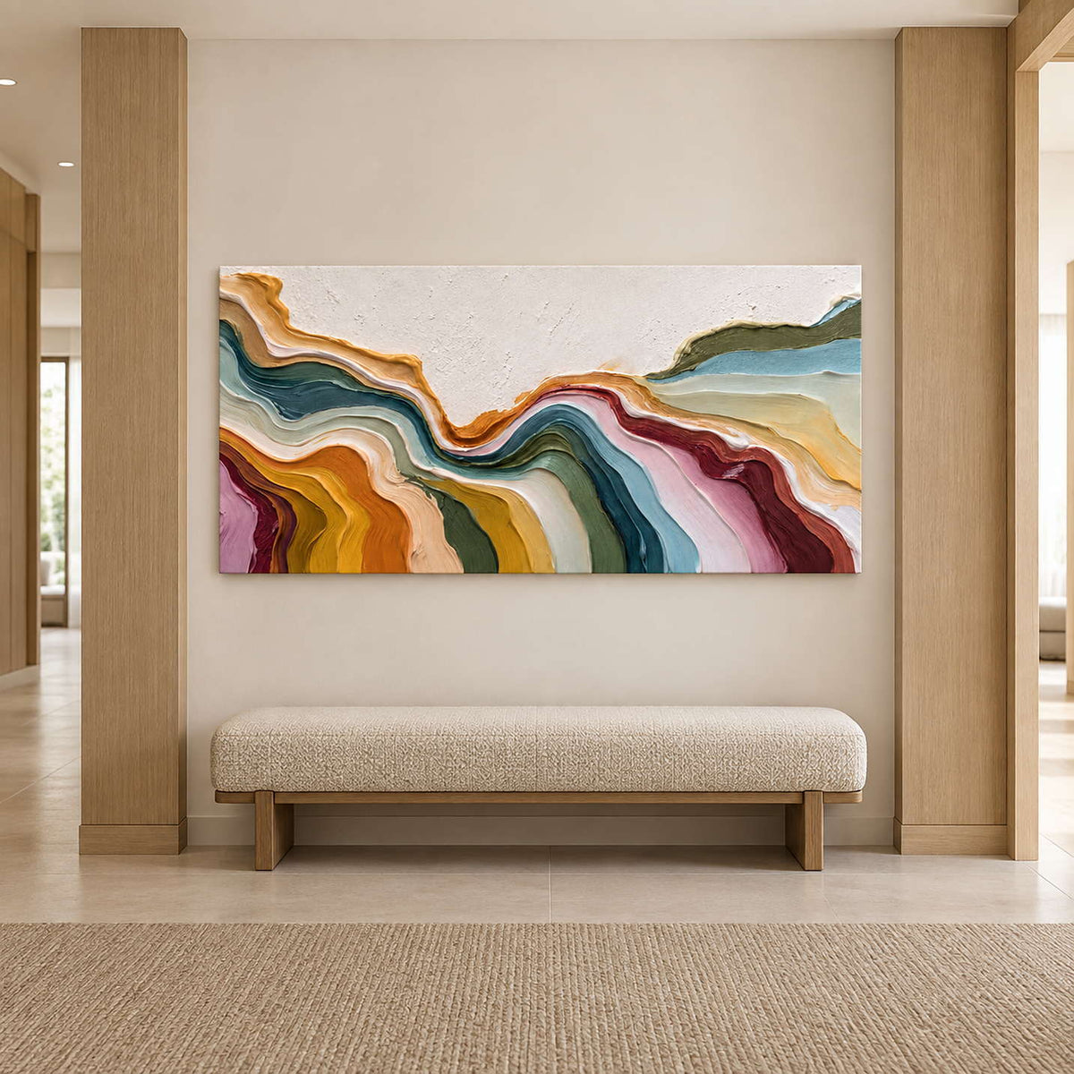 Colorful textured artwork above an upholstered bench between light wood wall panels.
