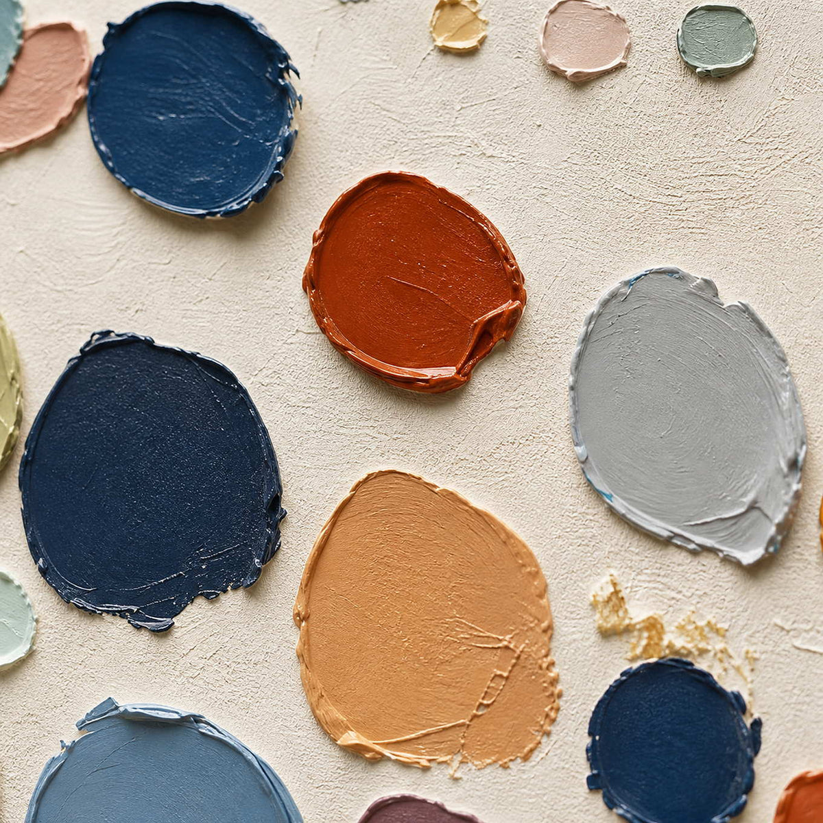 Close-up of raised navy, coral, sage, and gray palette-knife marks.