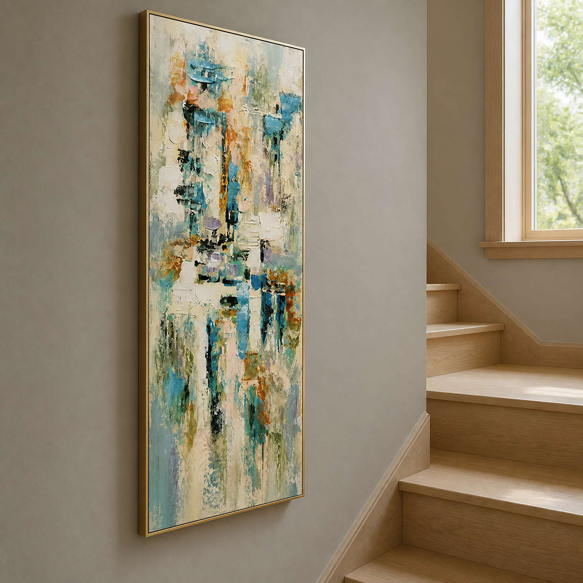Extra-tall colorful wall art displayed beside a light wood stairway.