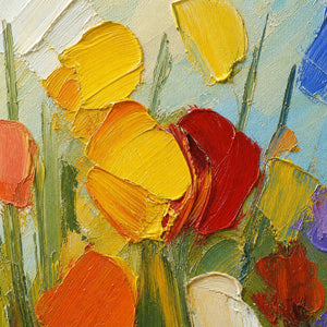 Close-up of thick yellow, orange, red, and green palette-knife texture.