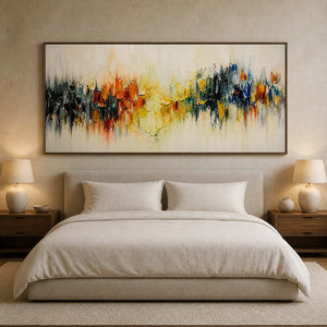 Panoramic multicolor canvas styled above a calm neutral bed.