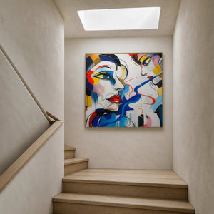 Graphic figurative artwork displayed at a light-filled stair landing.