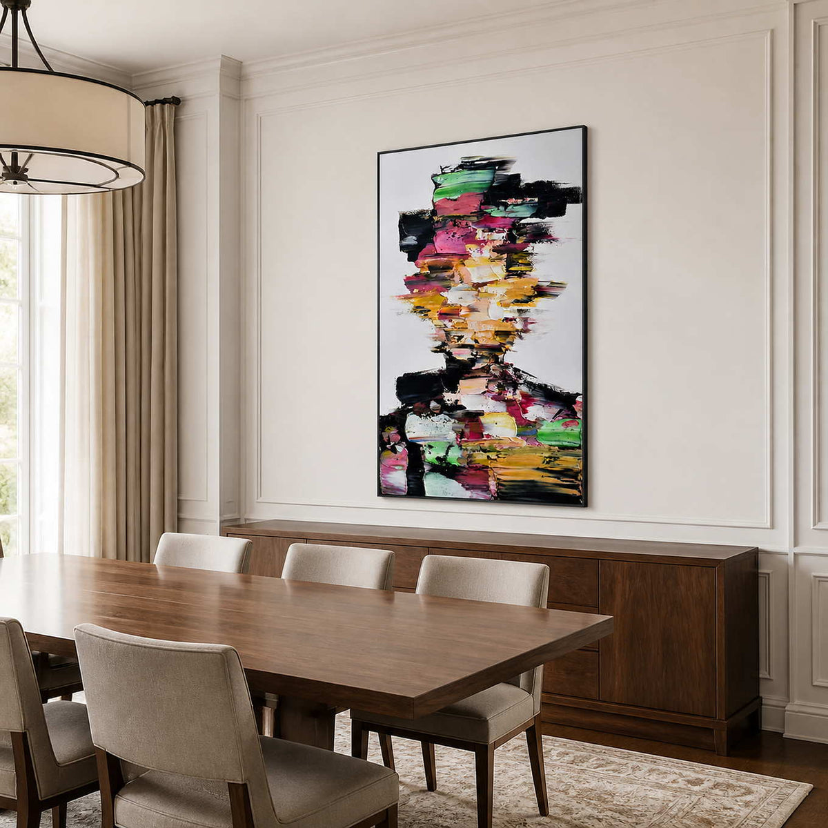 Black framed colorful portrait above a walnut sideboard beside a wooden dining table.