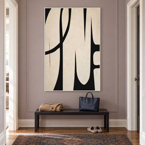 Cream and black abstract painting with elongated forms and a sweeping arc in a white frame in a hallway.