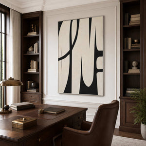 Silver framed cream abstract artwork between dark bookshelves behind a traditional wooden home office desk.