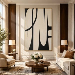 Gold framed cream and black curved artwork above lounge seating in a sunlit hotel lobby.