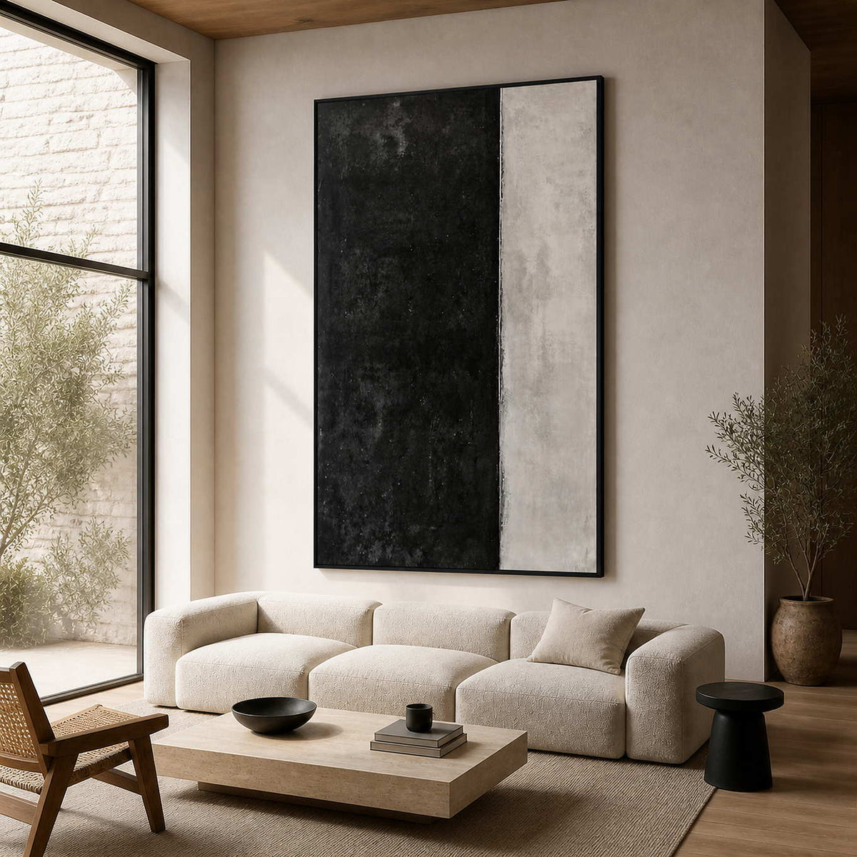 Company through the Long Night in a black frame above a cream sofa, with a pale vertical strip beside a broad charcoal field.