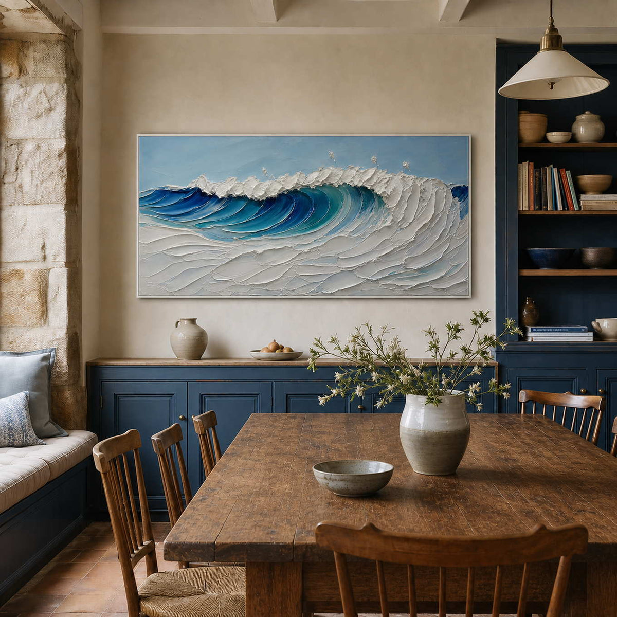 Textured ocean wall art displayed in a refined coastal dining room.