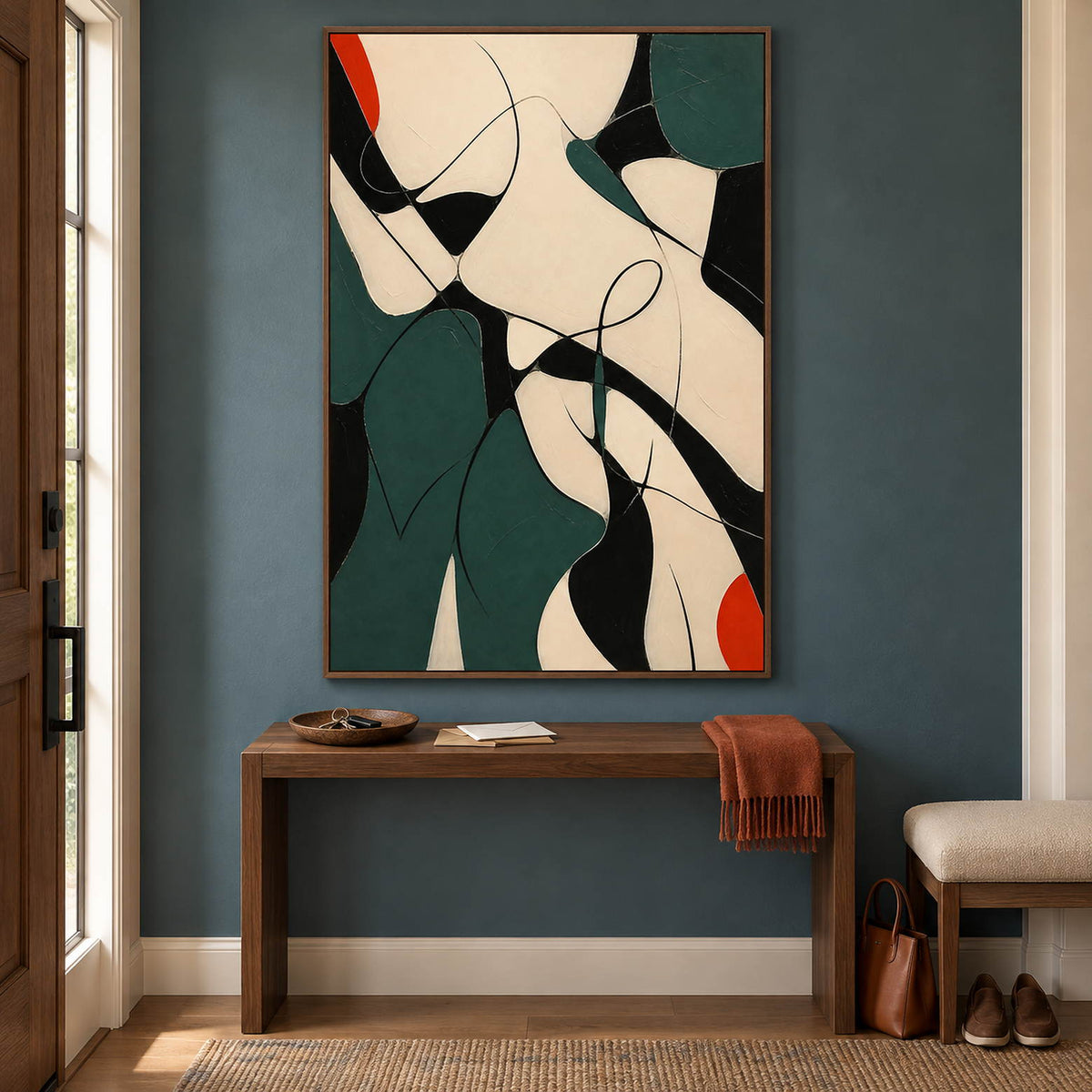 Deep green, black, and cream abstract painting with curved lines and red accents in a brown wood frame in an entryway.