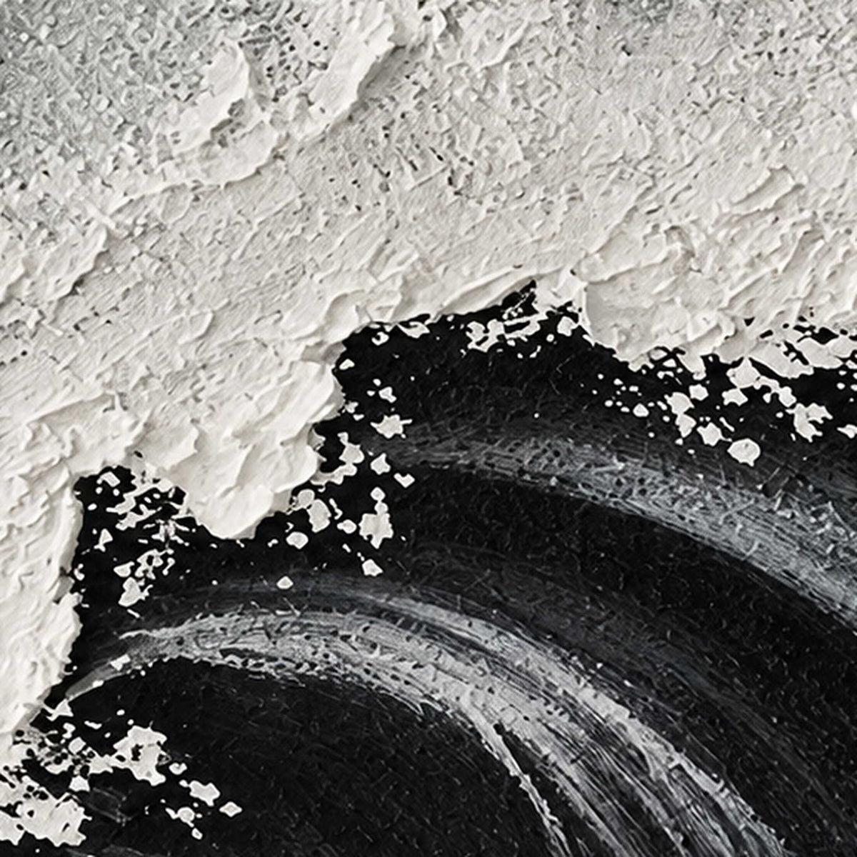 Close-up of layered white foam texture and fine gray ridges across black swells.