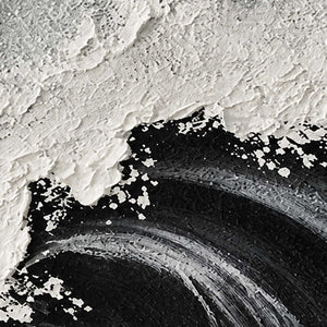 Close-up of layered white foam texture and fine gray ridges across black swells.