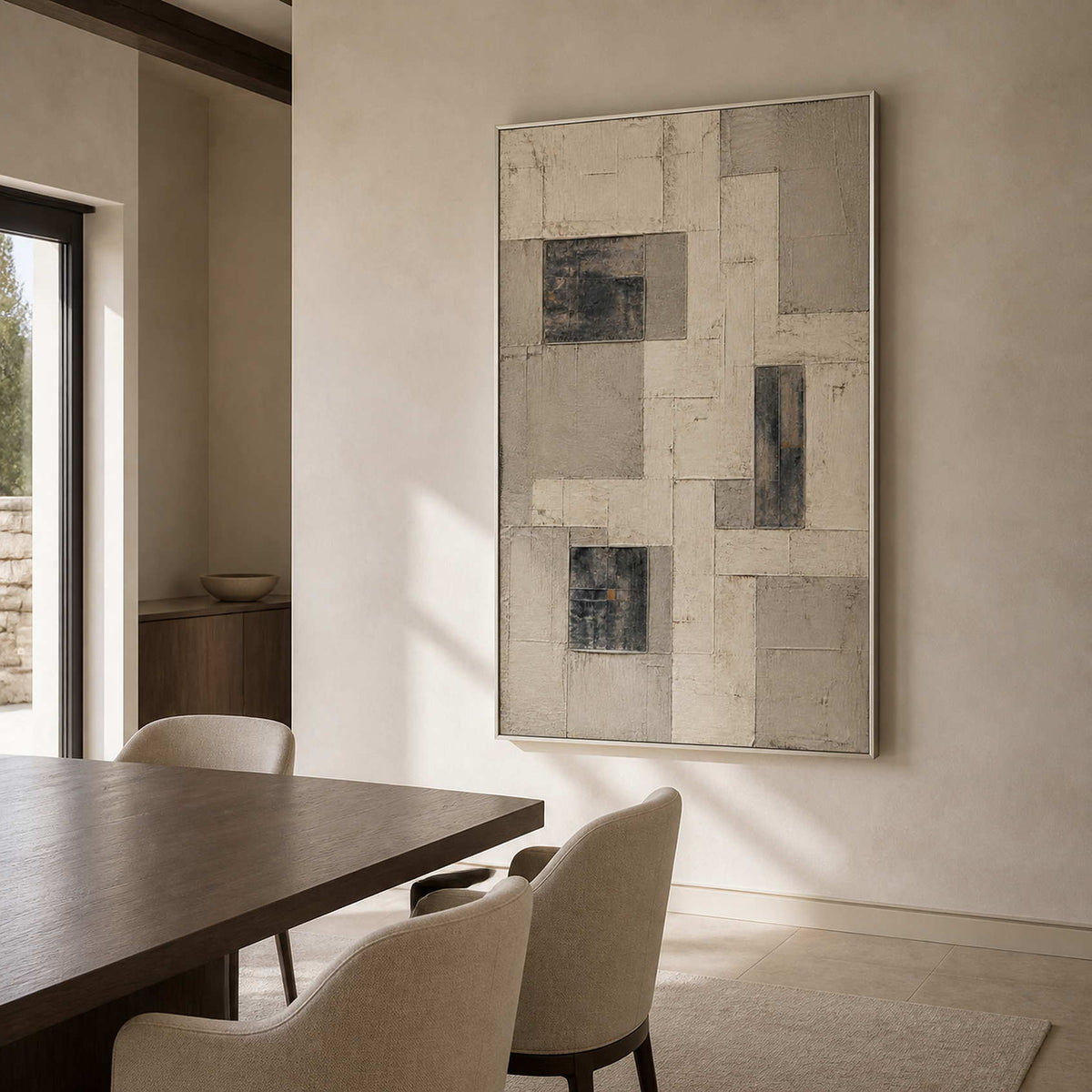 Architectural neutral wall art in a modern dining room with a silver frame.