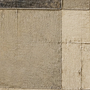 Close-up of scored ivory rectangles and weathered charcoal surface texture.