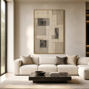 Textured neutral abstract wall art in a refined living room with a gold frame.