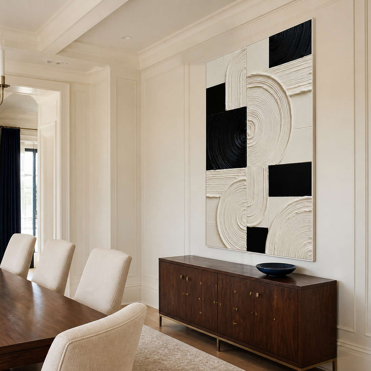 White framed geometric artwork beside a dining table and walnut sideboard.