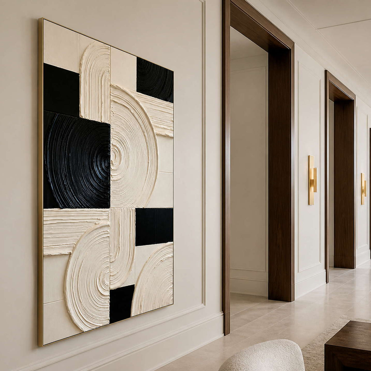 Gold framed geometric artwork along a cream hallway with dark doorways.