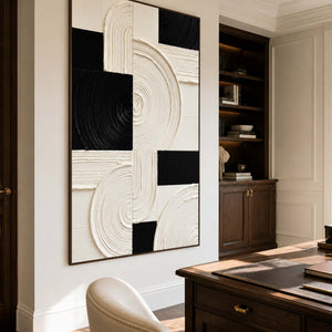 Wood framed textured arcs beside a writing desk and office bookshelves.