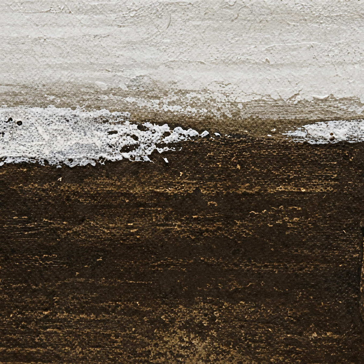 Close view of the textured boundary between pale gray and deep brown painted layers.