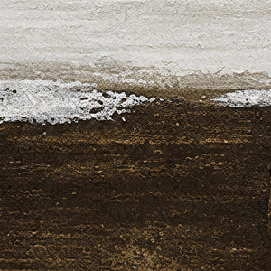 Close view of the textured boundary between pale gray and deep brown painted layers.