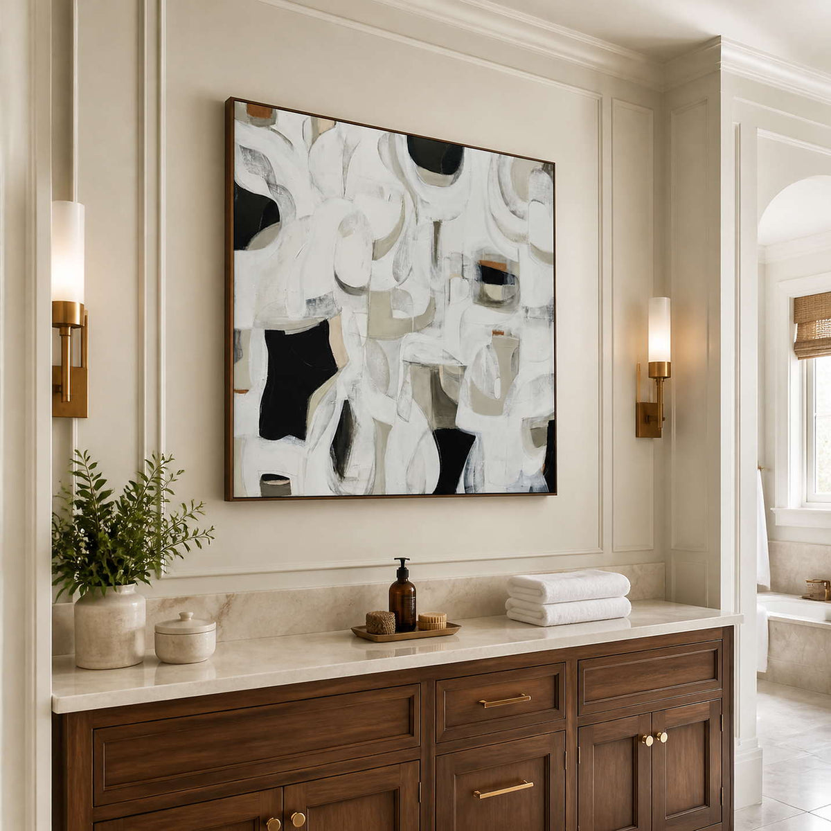 Wood framed white and gray abstract artwork above a vanity in a bathroom dry area.