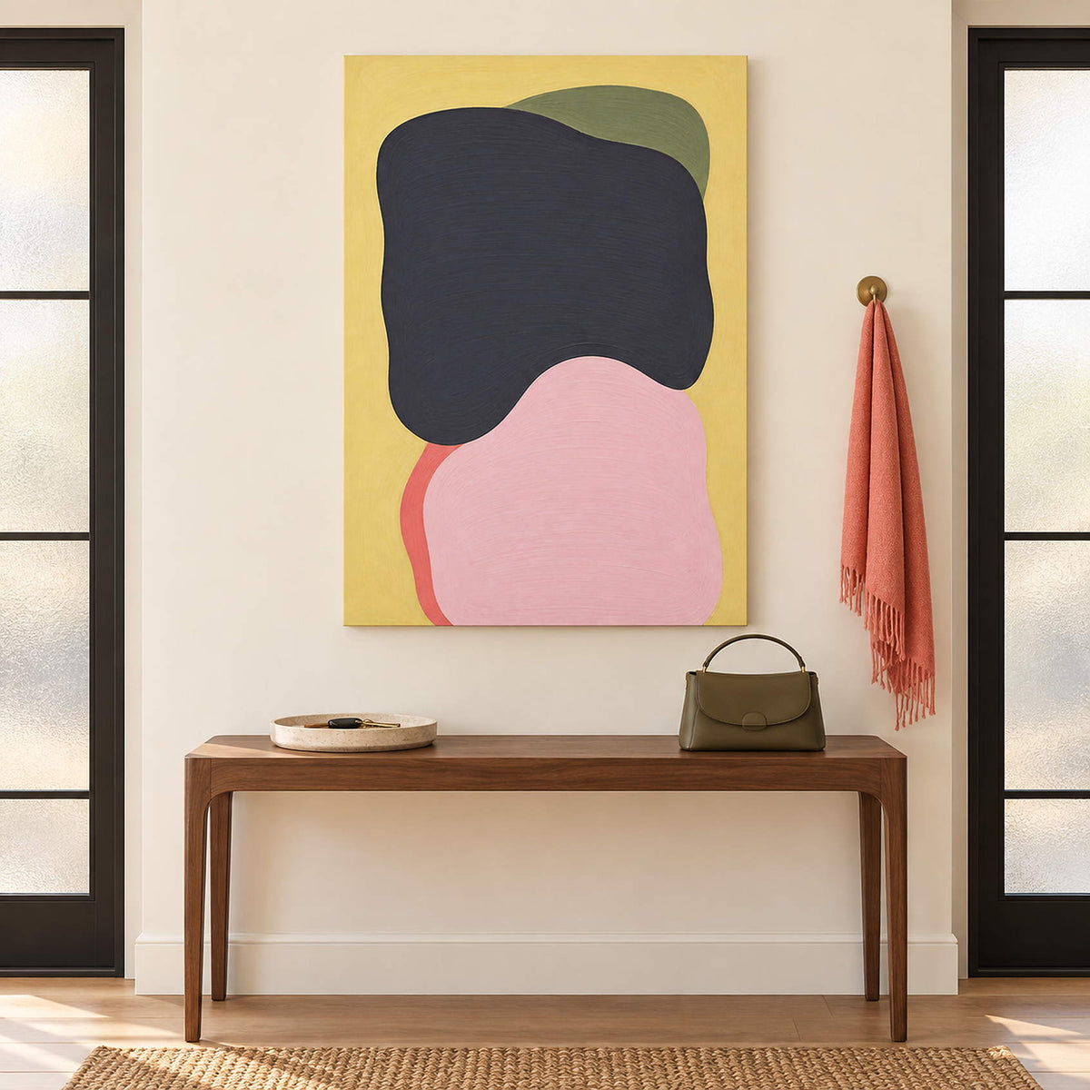Yellow abstract painting with charcoal, blush, olive, and coral shapes without an outer frame in an entryway.