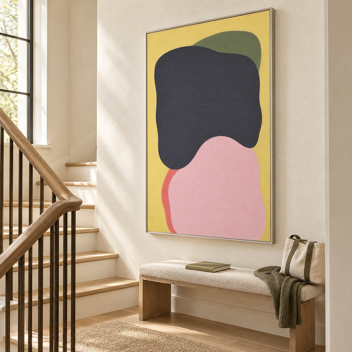 Yellow abstract painting with charcoal, blush, olive, and coral shapes in a silver frame on a stair landing.