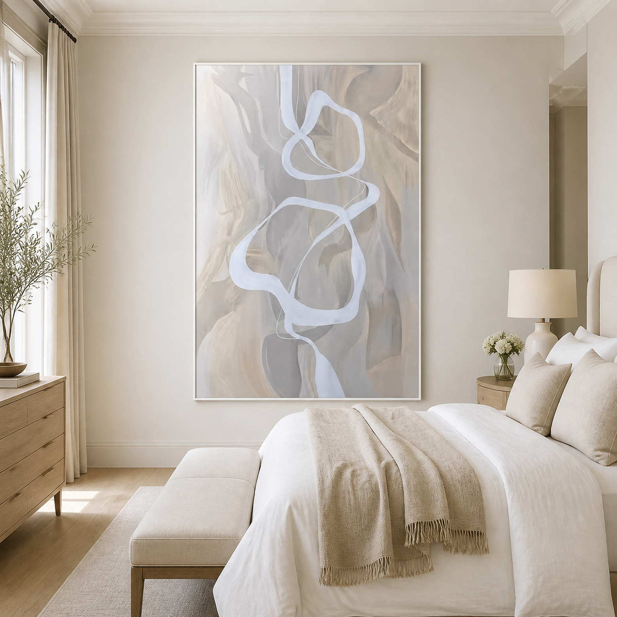 White framed flowing abstract artwork beside a neutral bed in a bright contemporary bedroom.