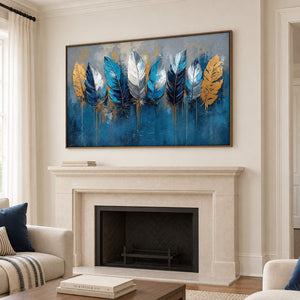 Blue, white and gold feathers against a deep blue and gray background in a brown wood frame, displayed above a fireplace.