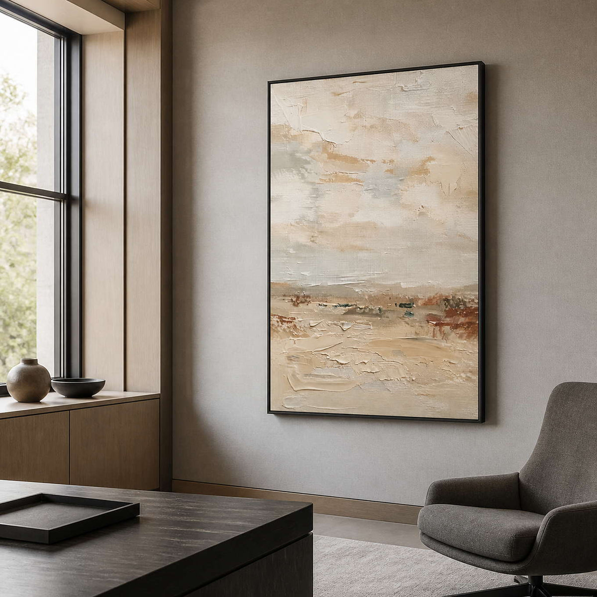 Black framed cream landscape painting displayed beside an executive office desk.