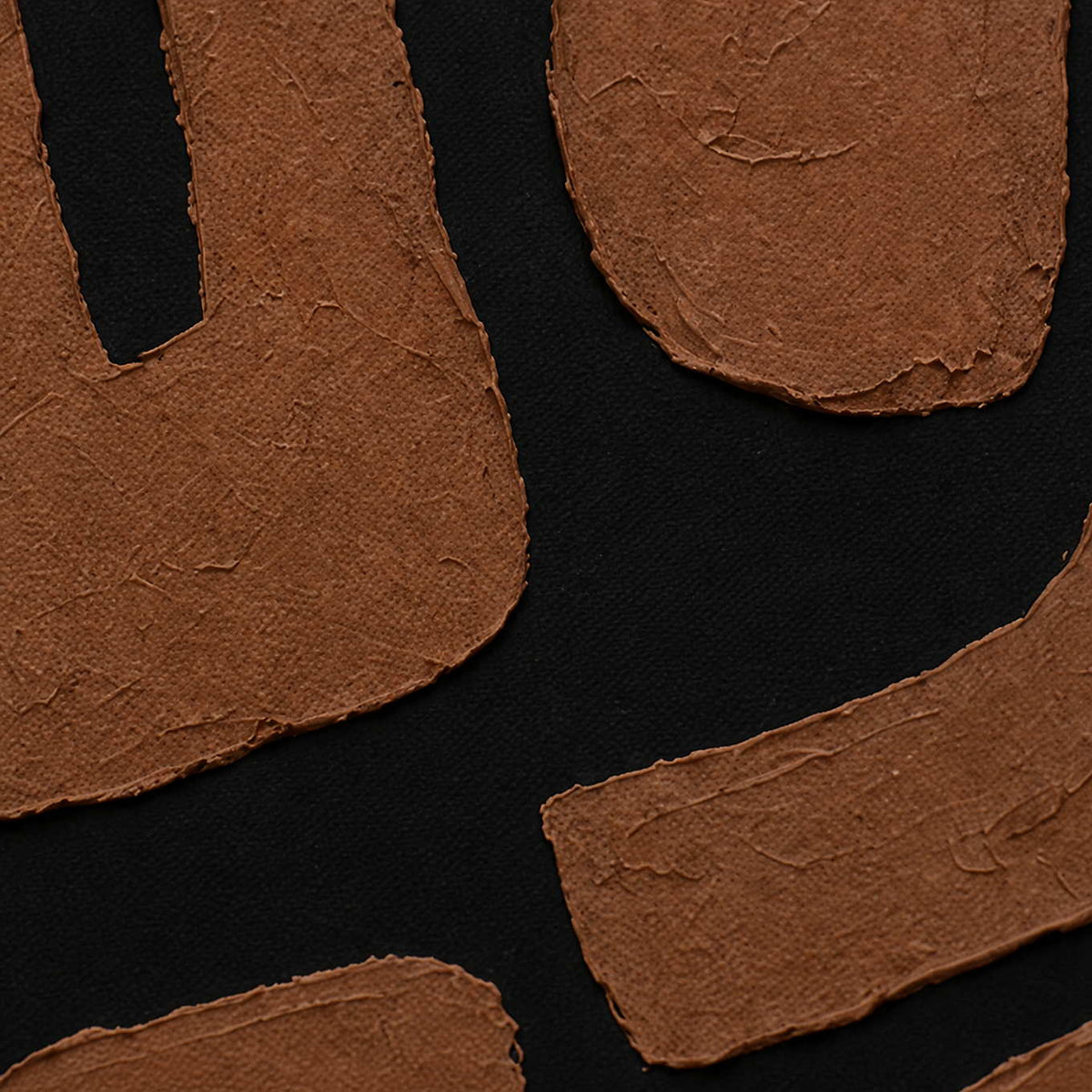 Close view of rust brown painted shapes with uneven edges over black canvas.