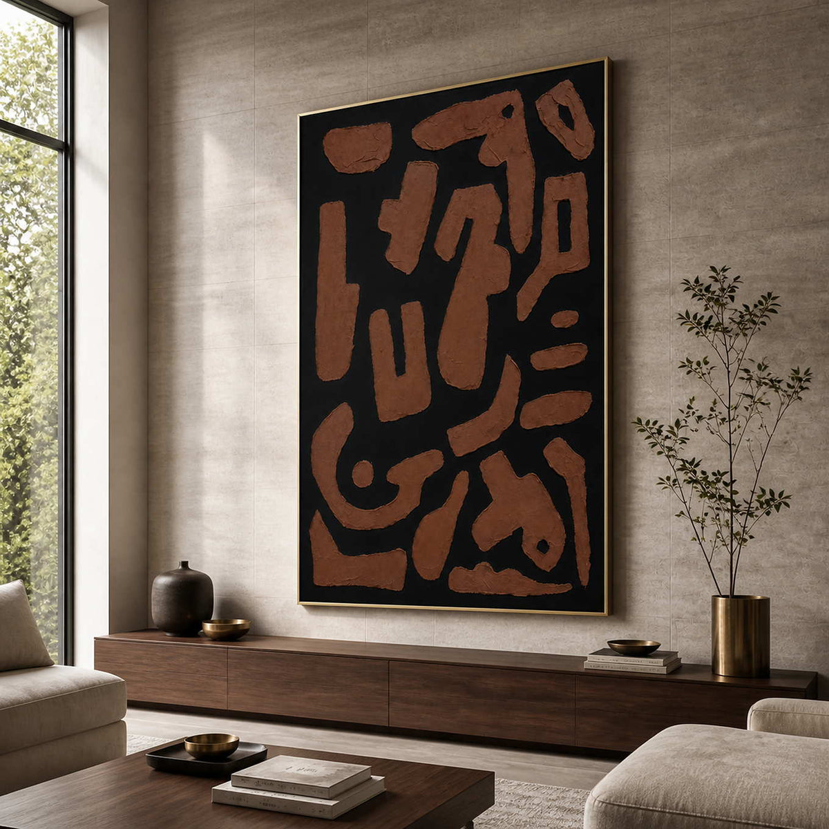 Gold framed rust and black abstract painting beside seating in a sunlit living room.