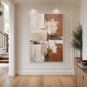 White-framed abstract wall art in a bright hallway beside a staircase.