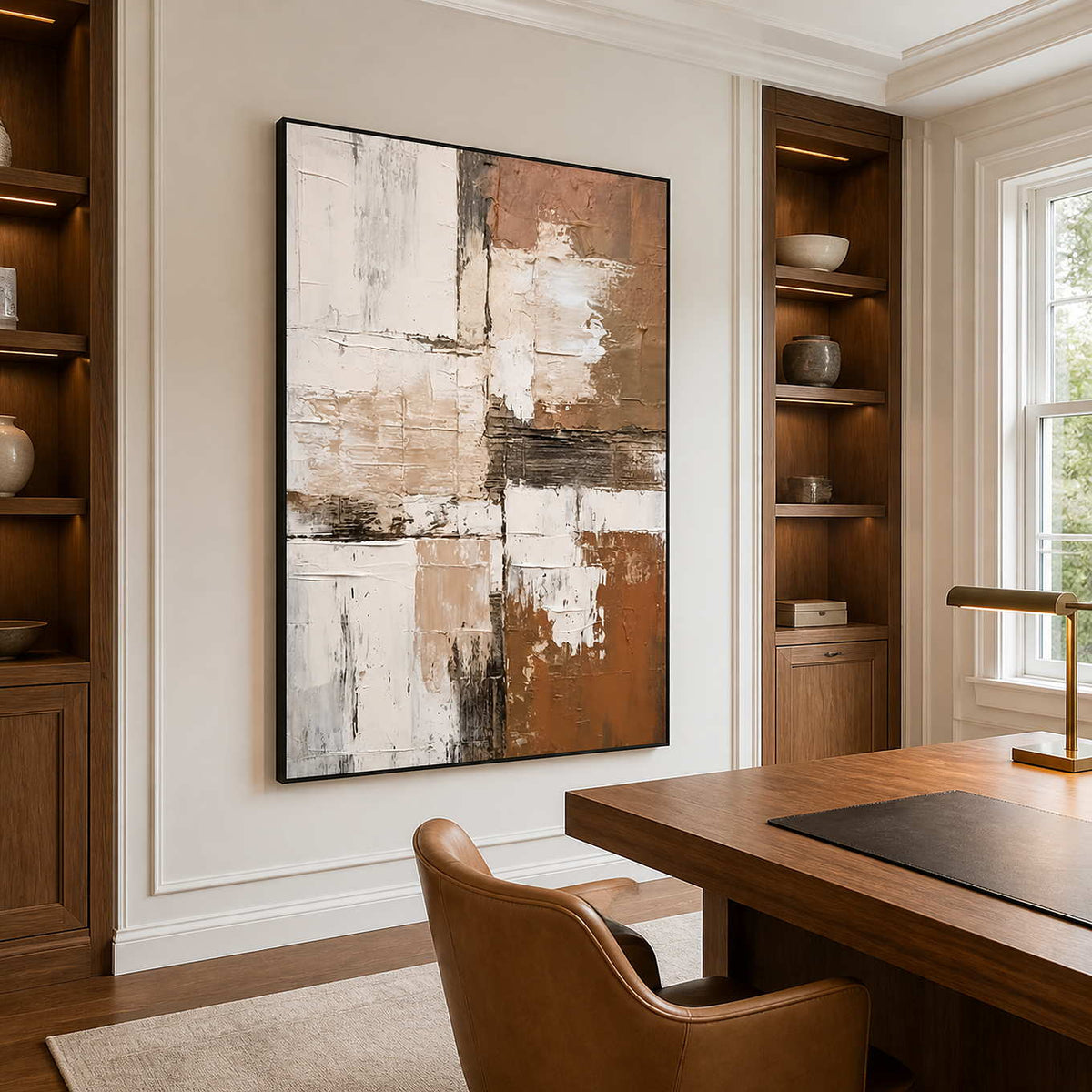 Black-framed textured abstract wall art beside a wooden desk and recessed bookcases.