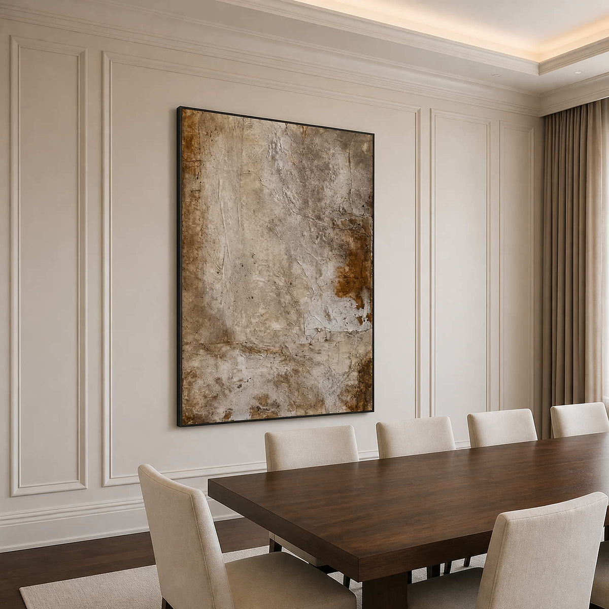 Black framed earthy abstract artwork beside a long walnut dining table.