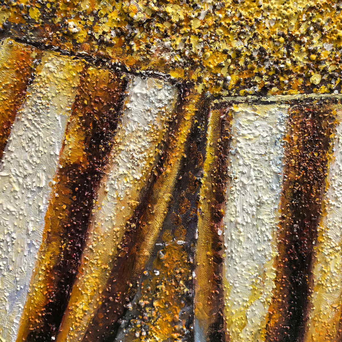 Close-up of bright and dark gold-colored highlights on two textured champagne cups.