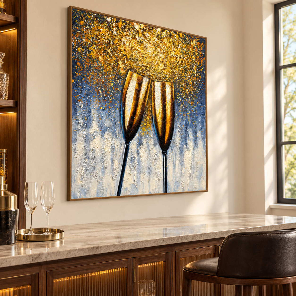 Artwork showing two golden champagne flutes leaning together beneath gold-colored speckles on blue gray above a home bar counter, with a brown wood-look frame.