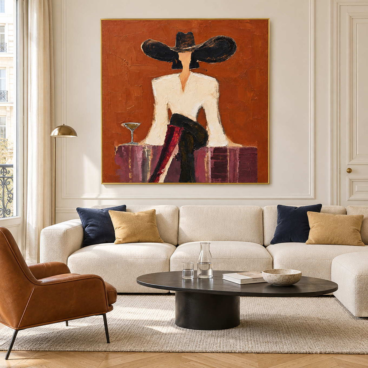 Orange figurative painting above a cream sofa with navy cushions.
