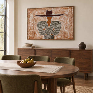 Effortless Poise in a wood frame above a sideboard behind a round wood dining table and olive chairs.