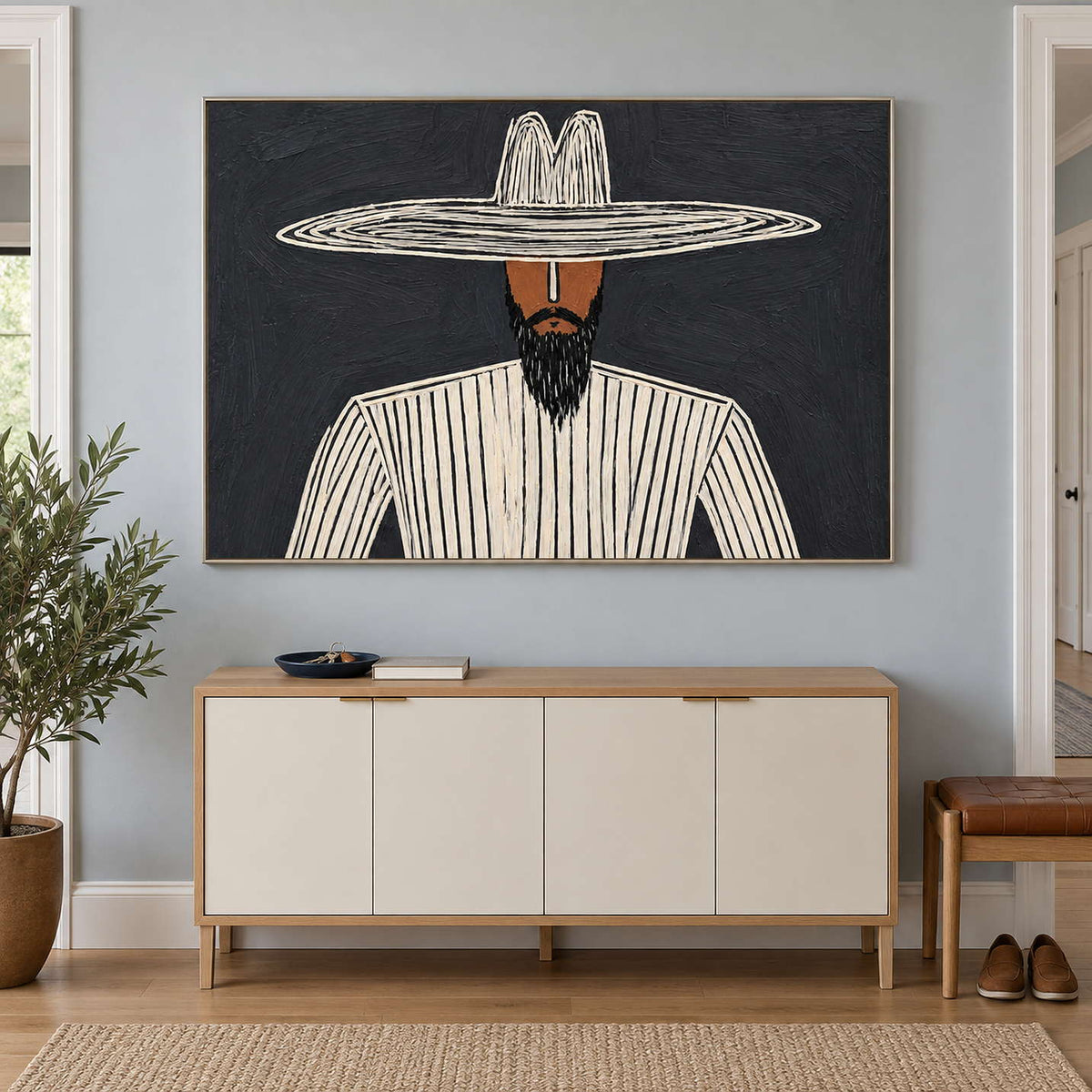 Horizontal striped portrait over a cream-fronted cabinet in a pale blue entryway.