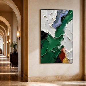 Vertical emerald abstract art in a softly lit arched hallway.