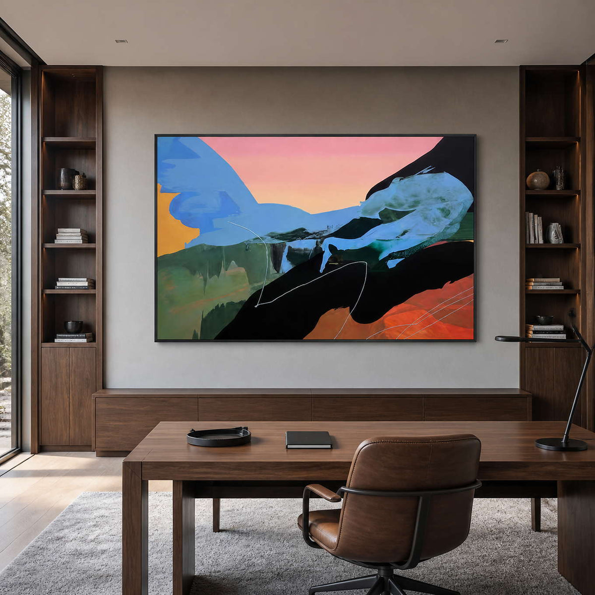 Wide blue and peach abstract painting in a black frame within a home study.