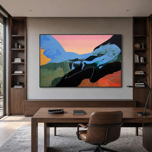 Wide blue and peach abstract painting in a black frame within a home study.