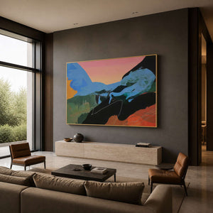 Blue and peach abstract painting with a gold frame in a boutique hotel lobby.