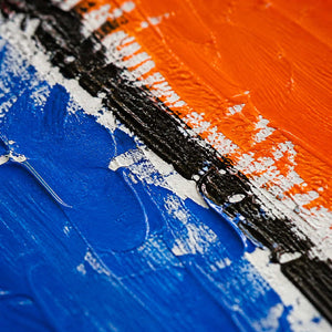 Close-up of orange, blue, black, and white painted texture.