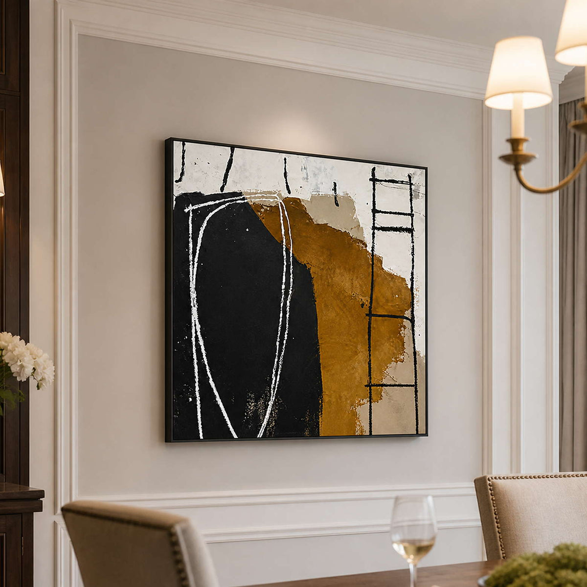 Black framed abstract painting beside upholstered dining chairs beneath softly shaded wall lights.