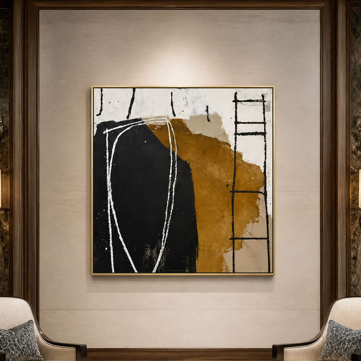 Gold framed abstract artwork between patterned chairs against a pale hotel lobby wall.