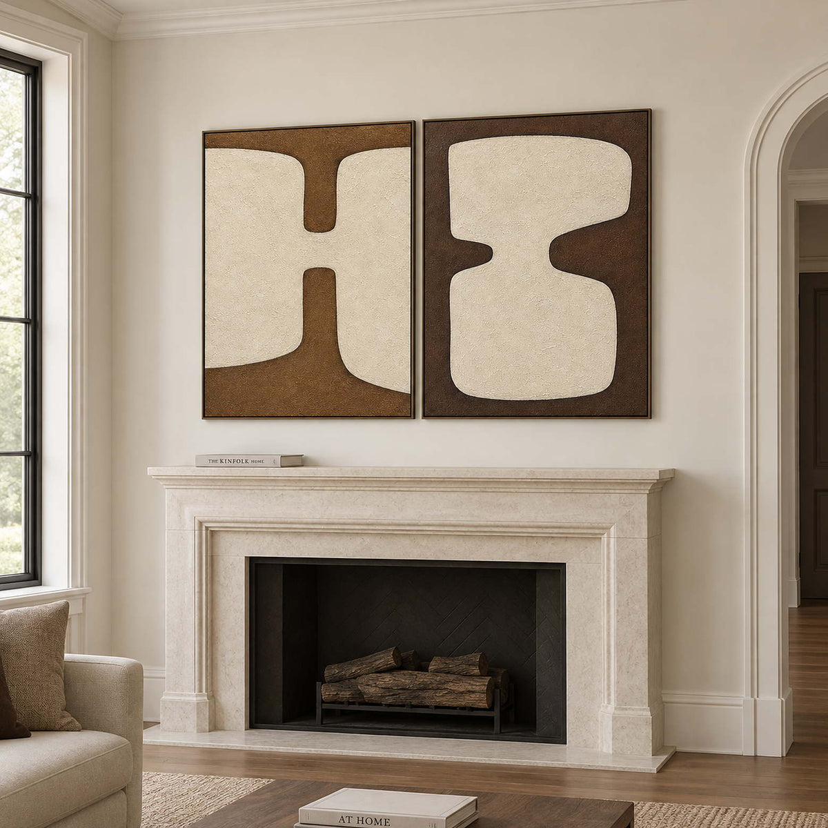 Two panels of complementary ivory organic forms on brown grounds in black frames, displayed above a fireplace.