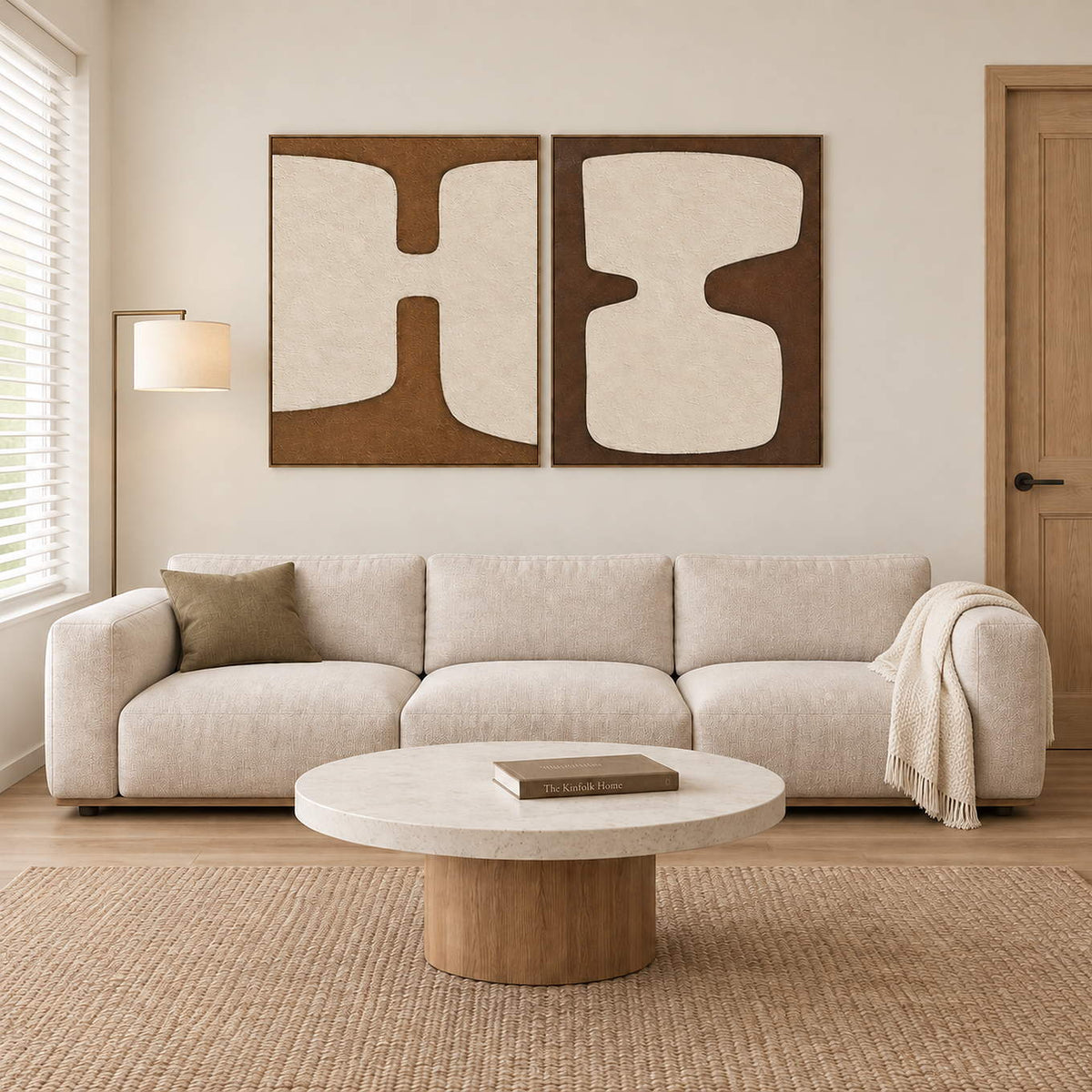 Two panels of complementary ivory organic forms on brown grounds in brown wood frames, displayed above a sofa in a living room.