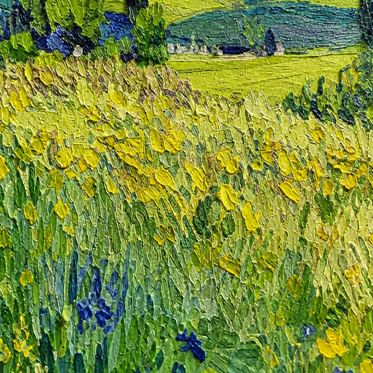Close view of raised yellow flower strokes and green meadow textures with blue accents.